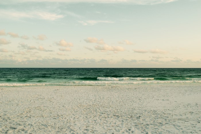 Beach with ocean waves and clouds