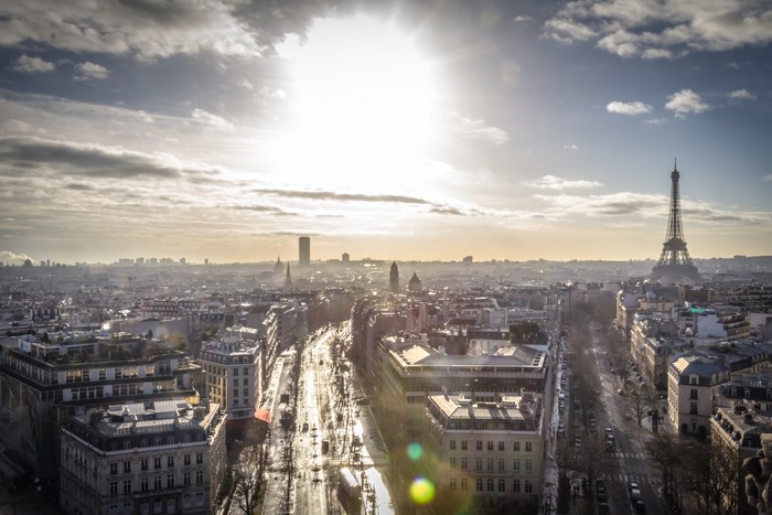 Paris cityscape with Eiffel Tower and sunburst