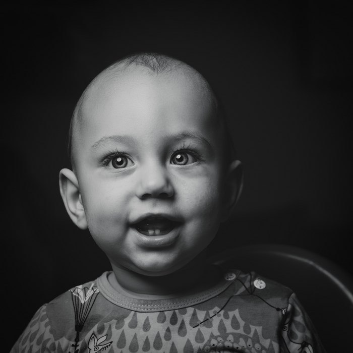 Black and white portrait of a smiling baby