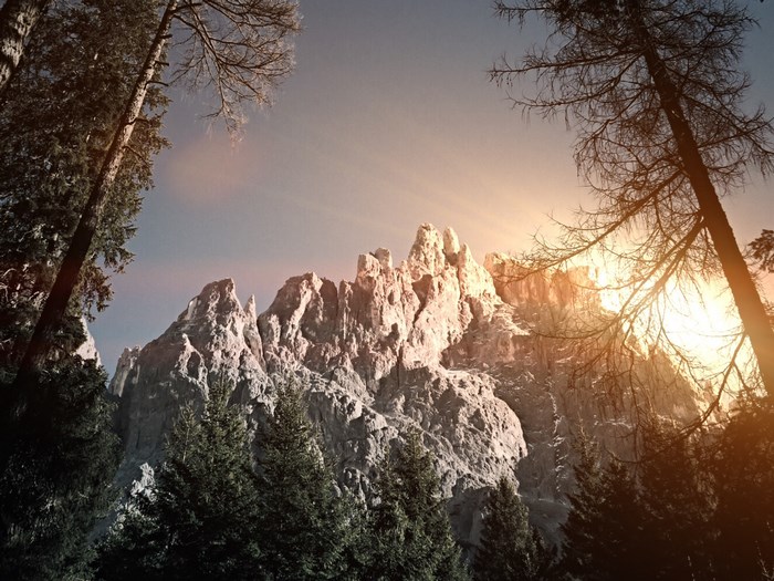 Sunlight illuminates jagged Dolomite mountains in Italy