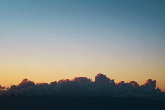 Clouds at sunset over a dark landscape