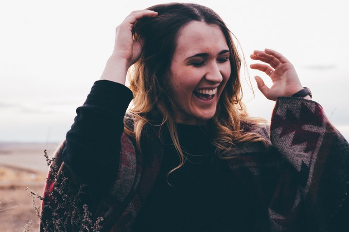 Young woman laughing outdoors