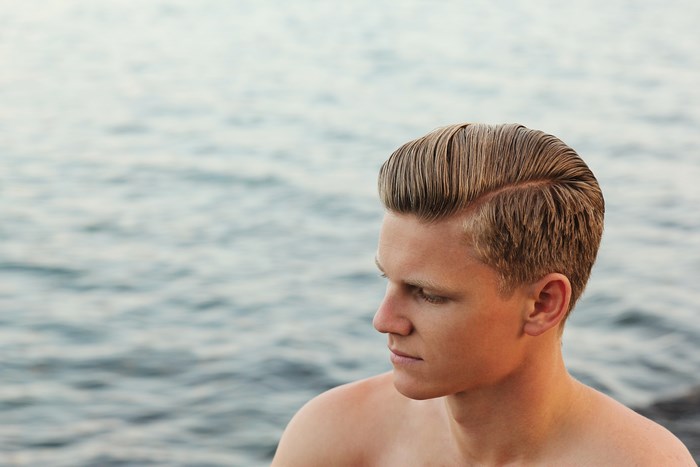 Man with styled hair by the water