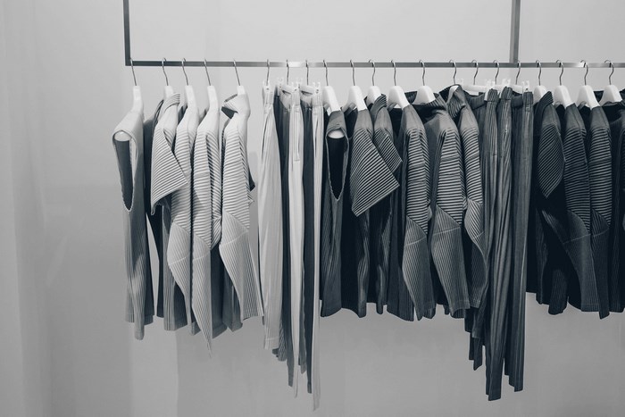 Minimalist fashion clothing rack with pleated garments