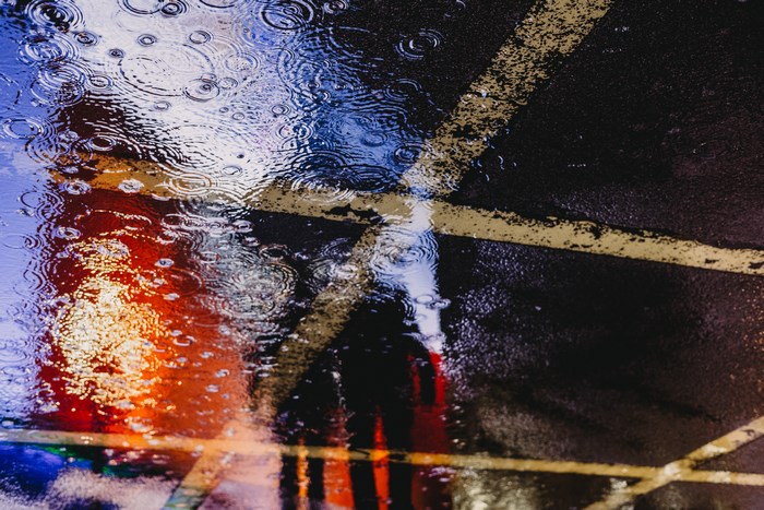 Rainy street reflection with yellow lines