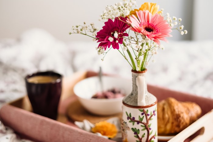Breakfast in bed with flowers and coffee