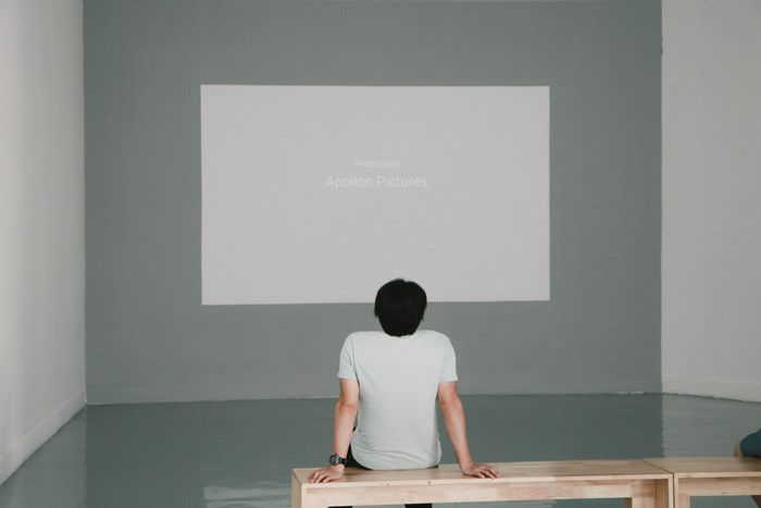 Man watches Apollon Pictures production on projection screen
