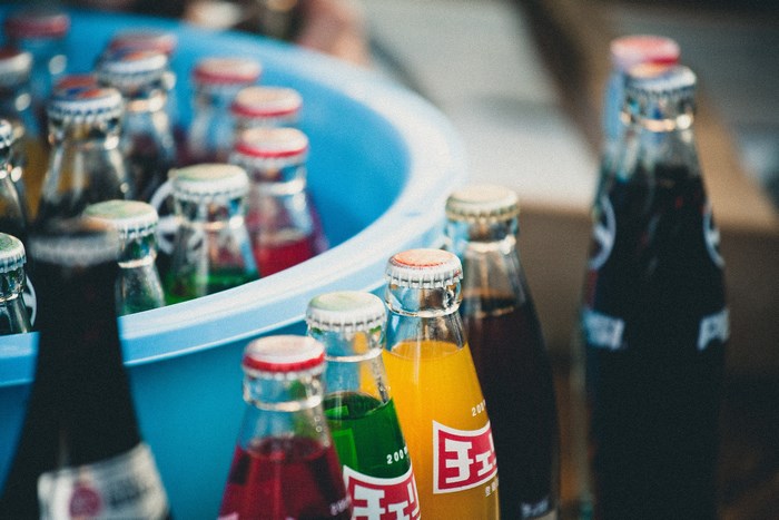Bottles of soda in a blue tub