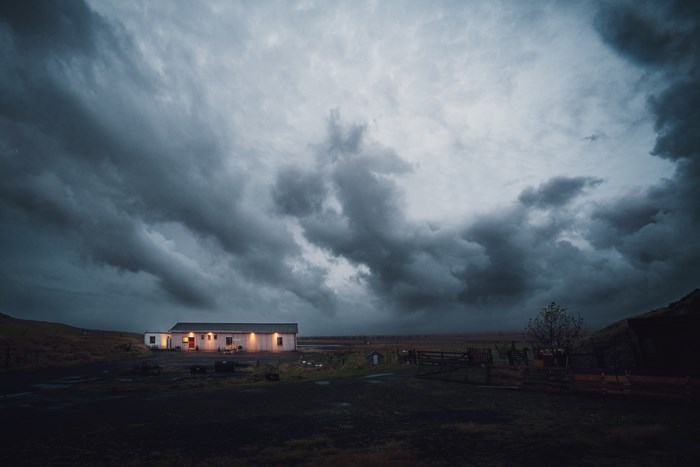 Remote house under stormy sky in Iceland