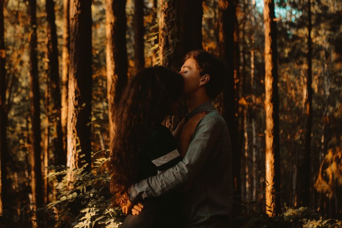 Couple embracing in a sunlit forest