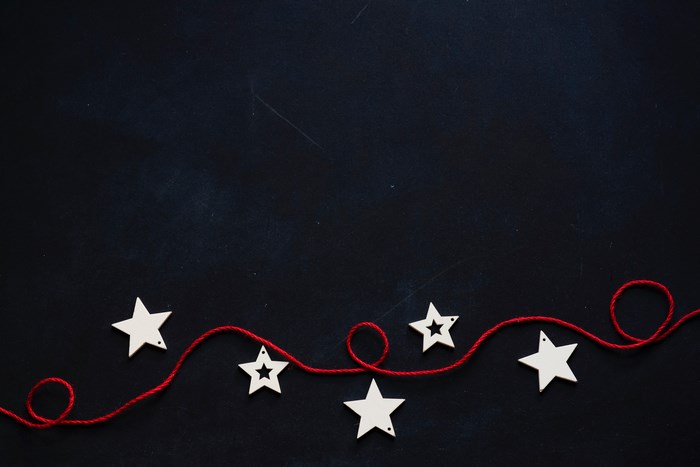 Red string with white stars on dark background