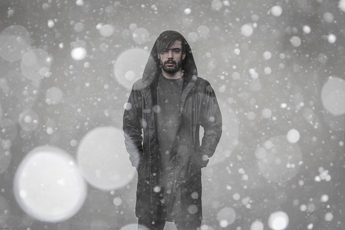 Man in a hooded coat in the snow in Asilah, Morocco