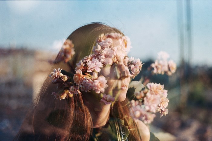 Double exposure of a woman with flowers in Kyiv
