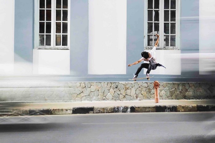 Man skateboarding in front of a building in Bandung
