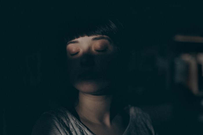 Woman with closed eyes in soft light