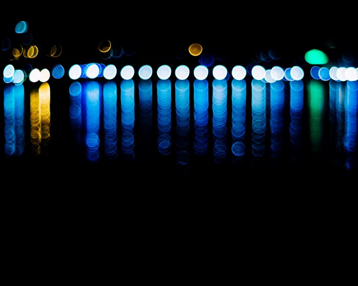 Abstract bokeh lights reflecting on water at night