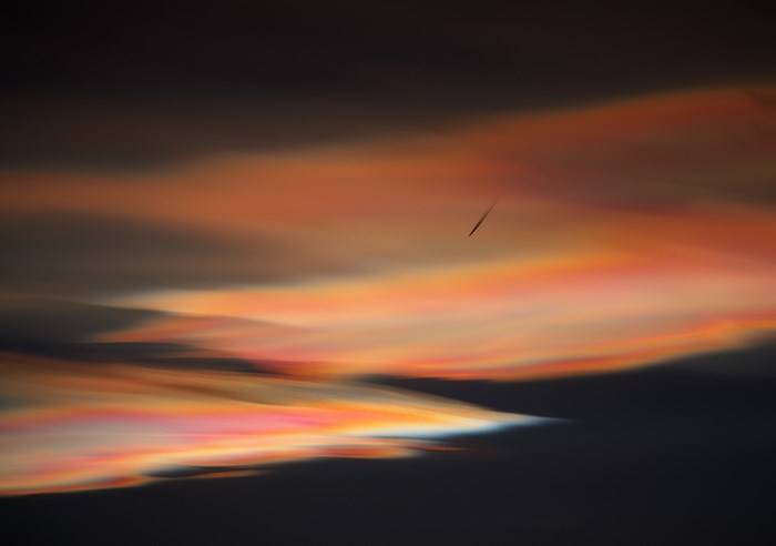 Polar stratospheric clouds with airplane trail