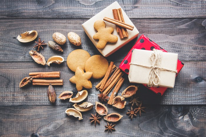 Christmas gifts and spices on a wooden table