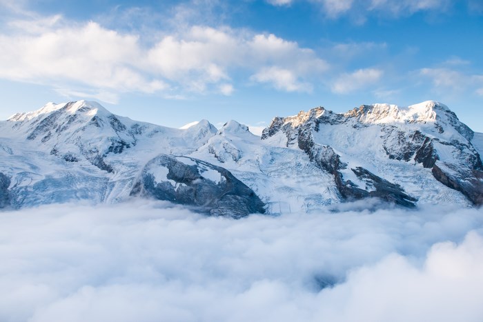Snow-Covered Swiss Mountains Above the Clouds
