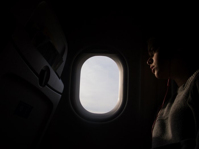 Passenger looking out airplane window