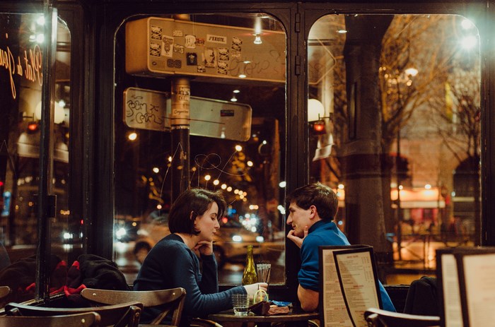 Couple at a Parisian cafe at night