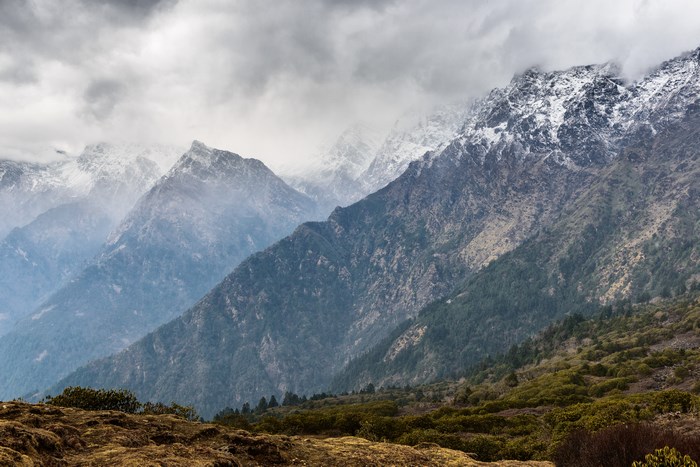 Snow-capped mountains in Langtang, Nepal under cloudy skies