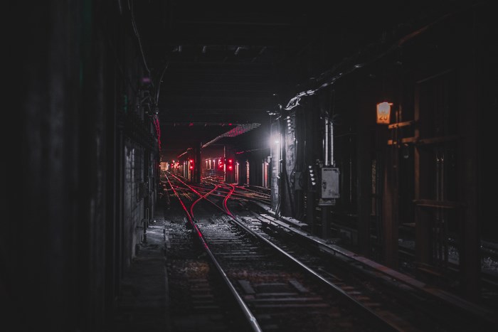 Dimly Lit New York Subway Train Tracks at Night