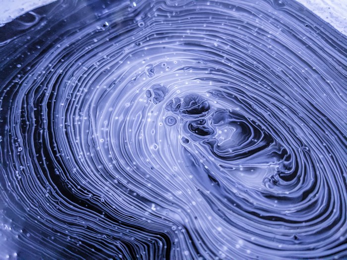 Abstract purple and black paint pour art