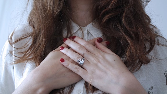 Woman with hands crossed over chest and rings