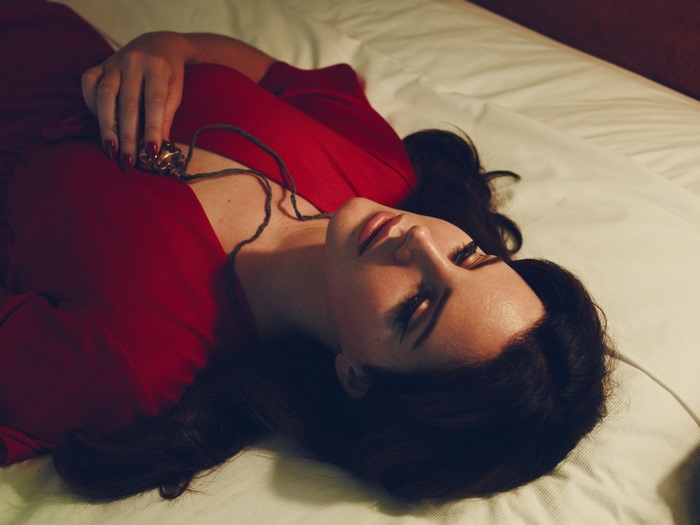 Lana Del Rey lying on a bed