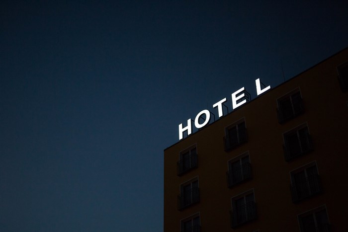 Hotel sign on a building at dusk