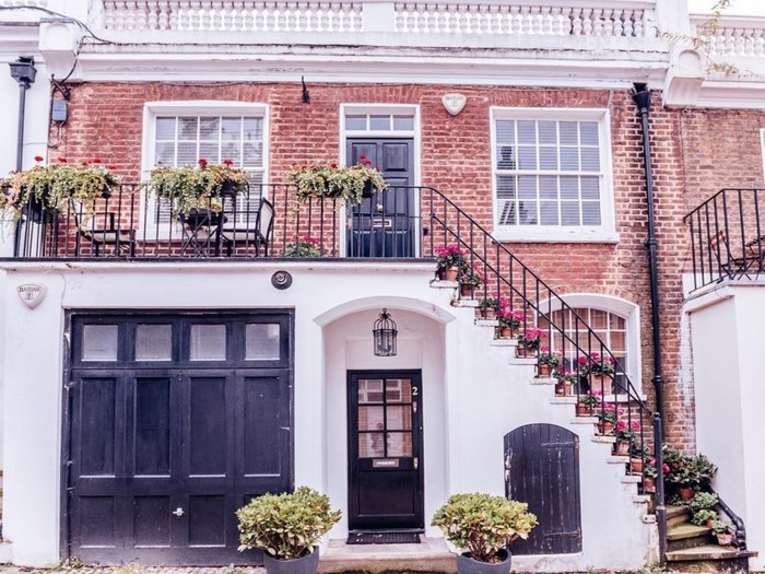 Terraced house with balcony and steps in London