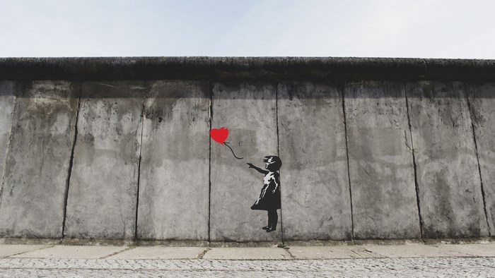 Girl with red balloon graffiti on Berlin Wall