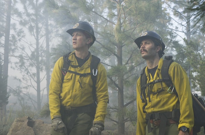 Two firefighters in a smoky forest