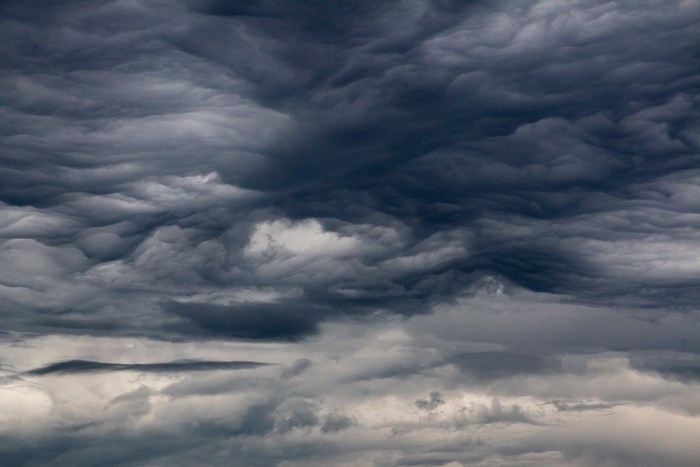 Dark, textured clouds in an overcast sky