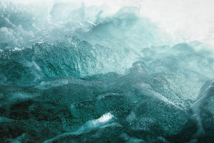 Close-up of turbulent turquoise water with bubbles