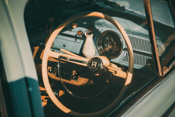 Vintage Volkswagen Beetle car interior dashboard and steering wheel
