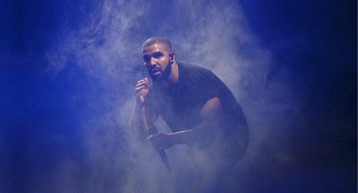 Drake performing on stage with smoke
