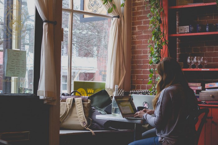 Woman working on a laptop in a cafe
