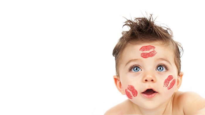 Cute baby with lipstick kisses