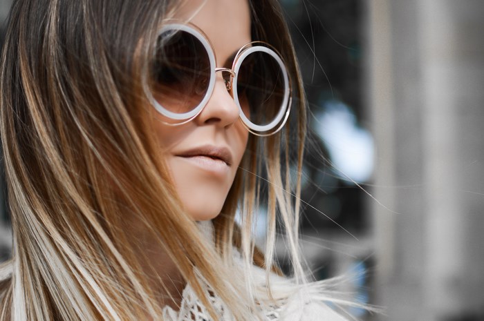 Stylish Blonde Woman Wearing Large Round Sunglasses