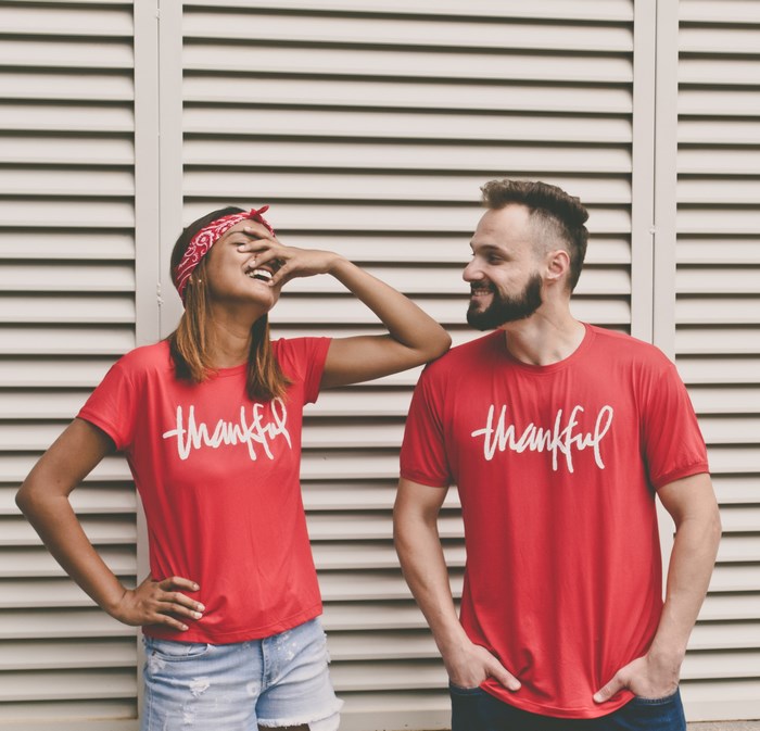 Couple wearing "thankful" t-shirts