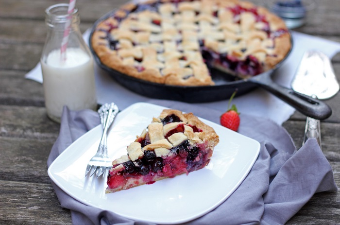 Berry pie in cast iron skillet with milk