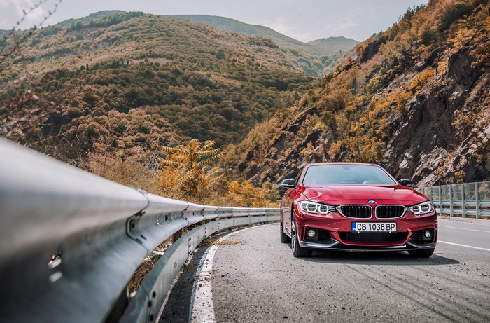 Red BMW 440i on a mountain road