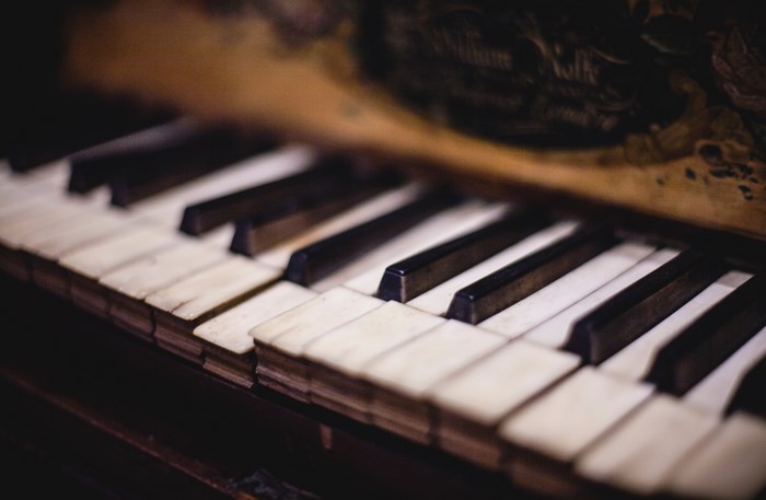 Close-up of vintage piano keys with bokeh