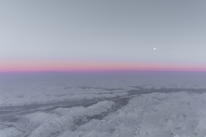 Snowy Mountains Under a Pink and Purple Sunset Sky