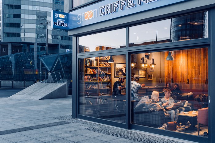 Cozy urban coffee shop with people working and studying