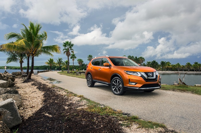 Orange Nissan Rogue SL on a coastal road