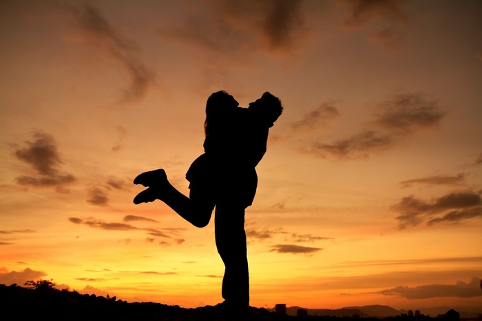 Couple embracing at sunset