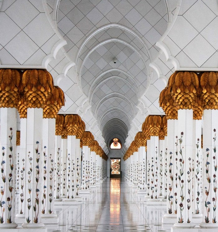 Interior of a mosque with ornate pillars and arches